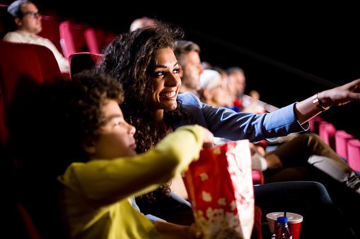 Happy woman enjoying a show with her son