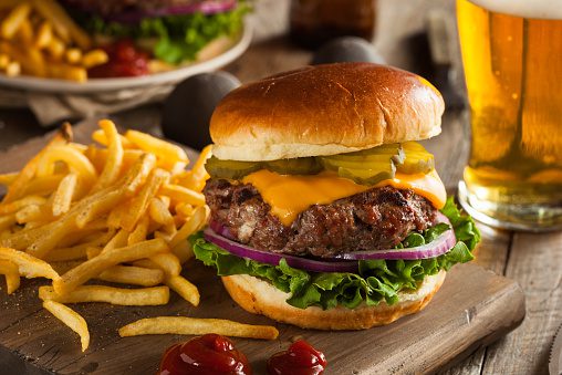 Burger and fries accompanied by a beer at a restaurant