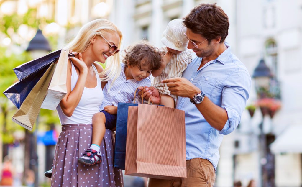 A family shopping outside at Barefoot Landing.