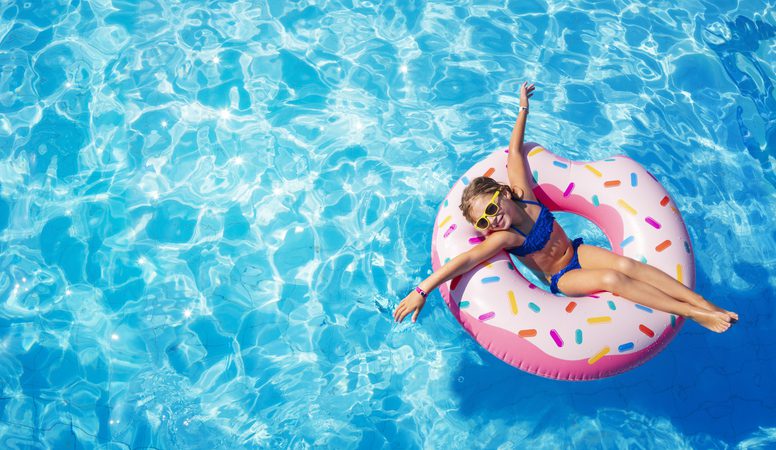Little girl on donut float in myrtle beach hotel with lazy river